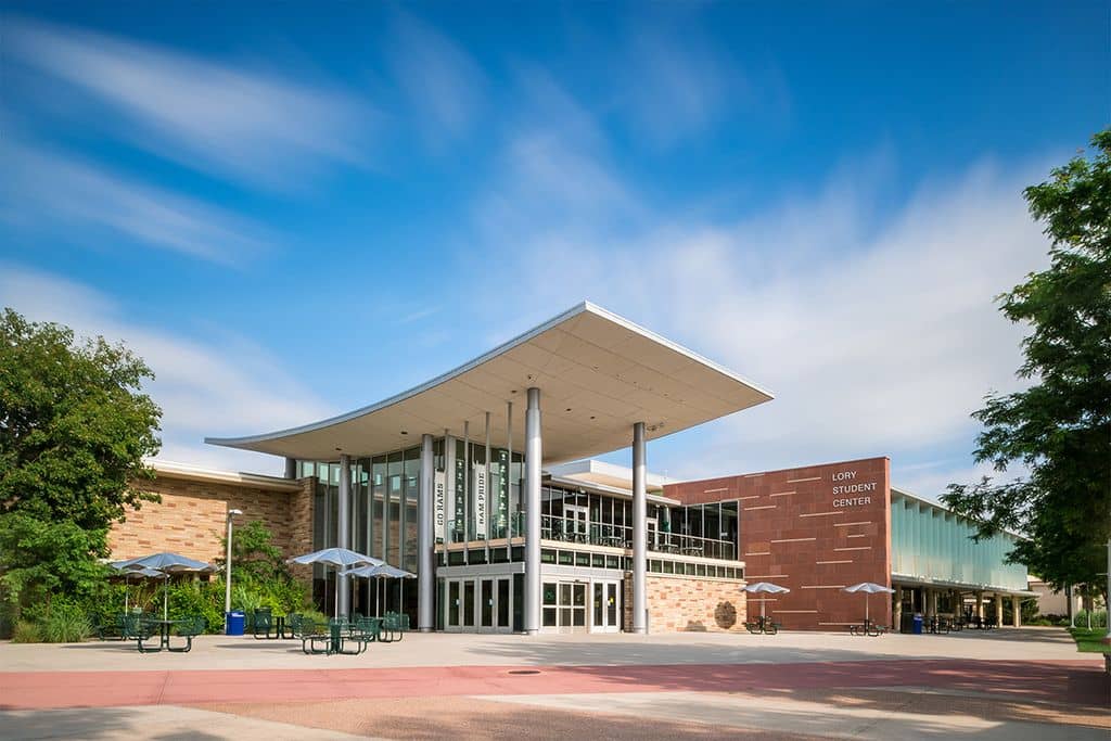 The main entrance of the Lory Student Center, a low building with a sweeping cantilevered roof and its name on the brick facade.